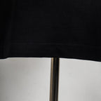 Givenchy black T-shirt hem and stitched seam close-up.
