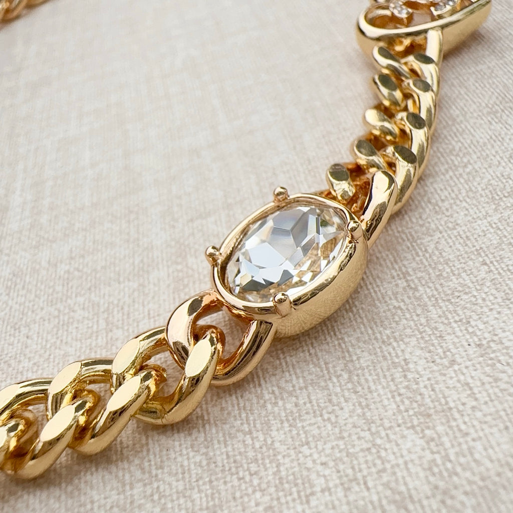 Chanel belt close-up with gold-tone chain and oval clear crystal charm