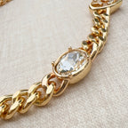 Chanel belt close-up with gold-tone chain and oval clear crystal charm