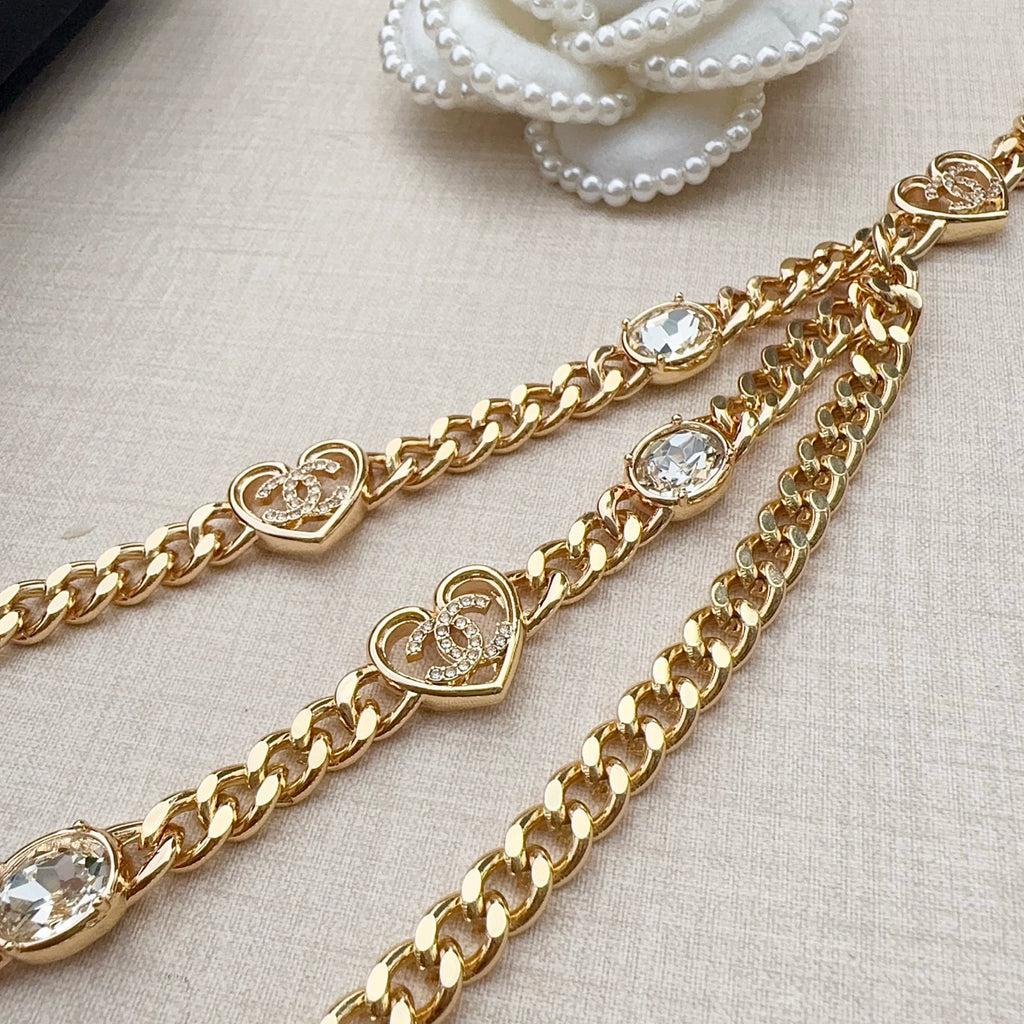 Chanel belt close-up with gold-tone chain, heart medallions, and clear crystal stones