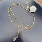 Chanel belt with gold-tone chain, heart charm accents, and white flower center detail