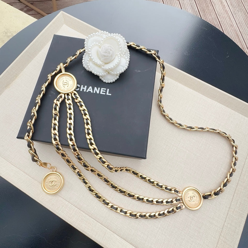 Gold-tone chain belt with round logo medallions and pearl flower centerpiece