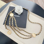 Gold-tone chain belt with round logo medallions and pearl flower centerpiece
