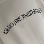 Close view of black logo text on white short-sleeve T-shirt