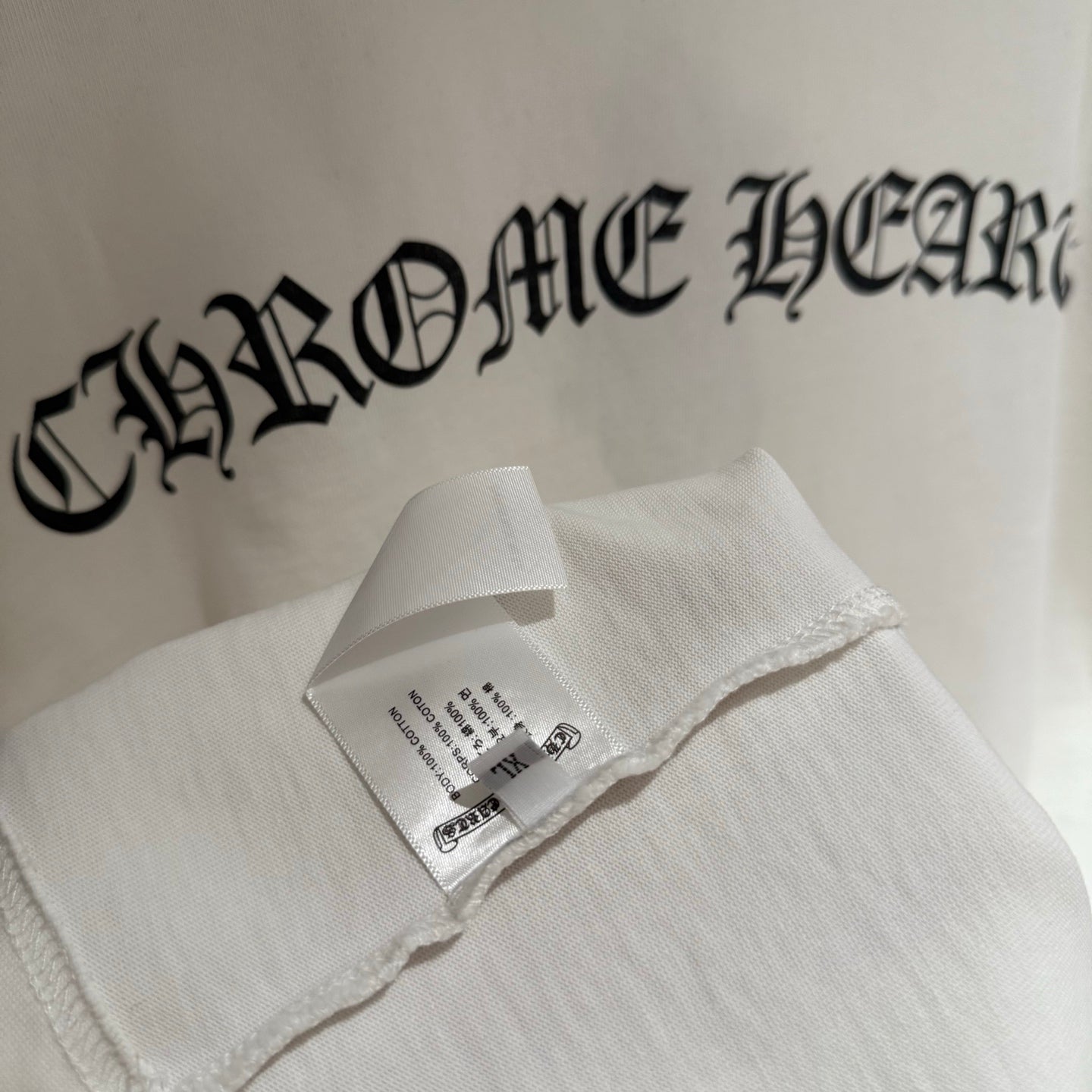 White short-sleeve T-shirt tag inside collar with large logo text
