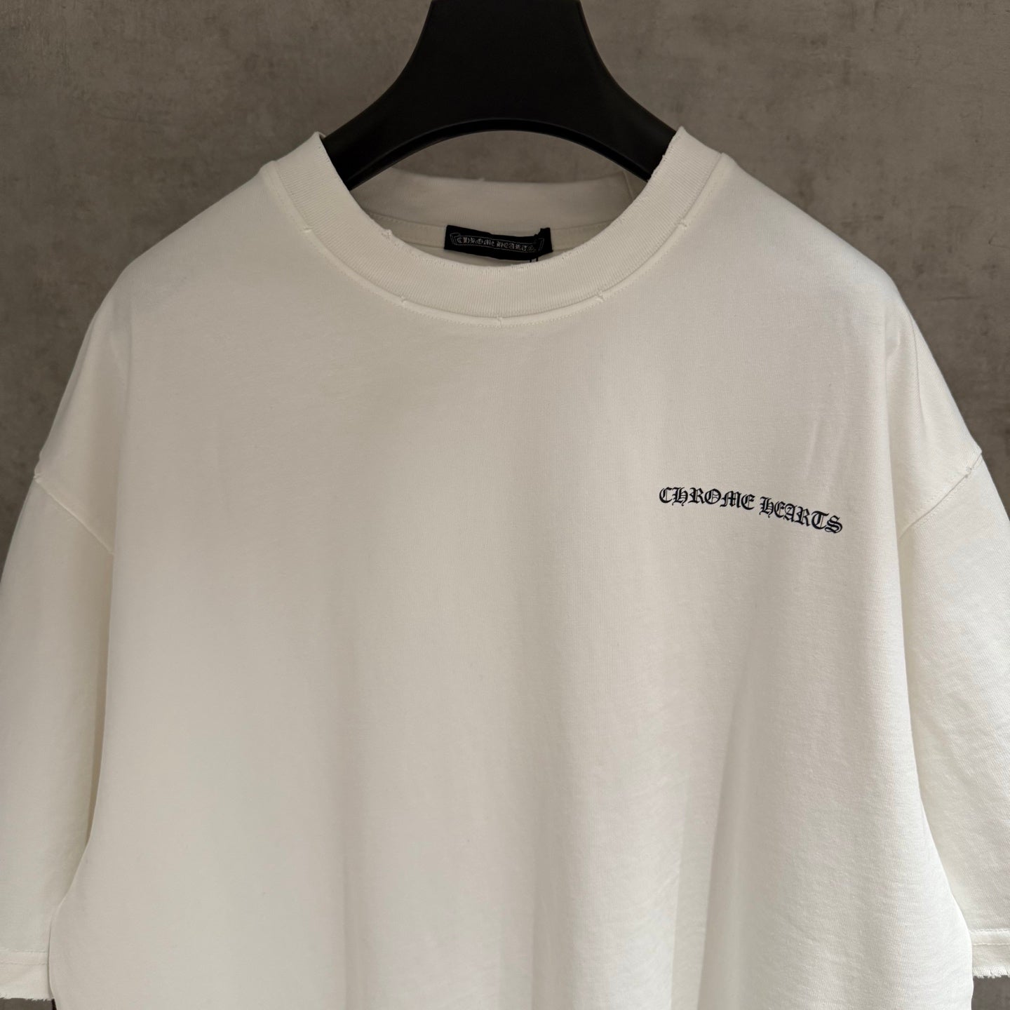 White short-sleeve T-shirt with small chest logo and crew neck