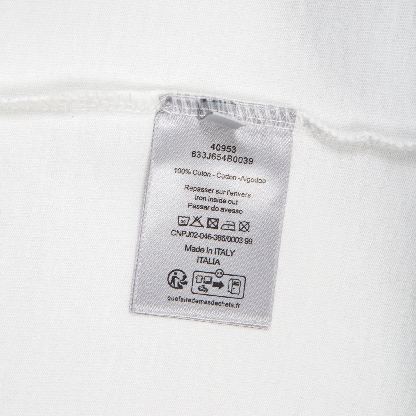 White T-shirt care label: 100% cotton, made in Italy