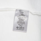 White Dior T-shirt care label with 100% cotton and wash instructions