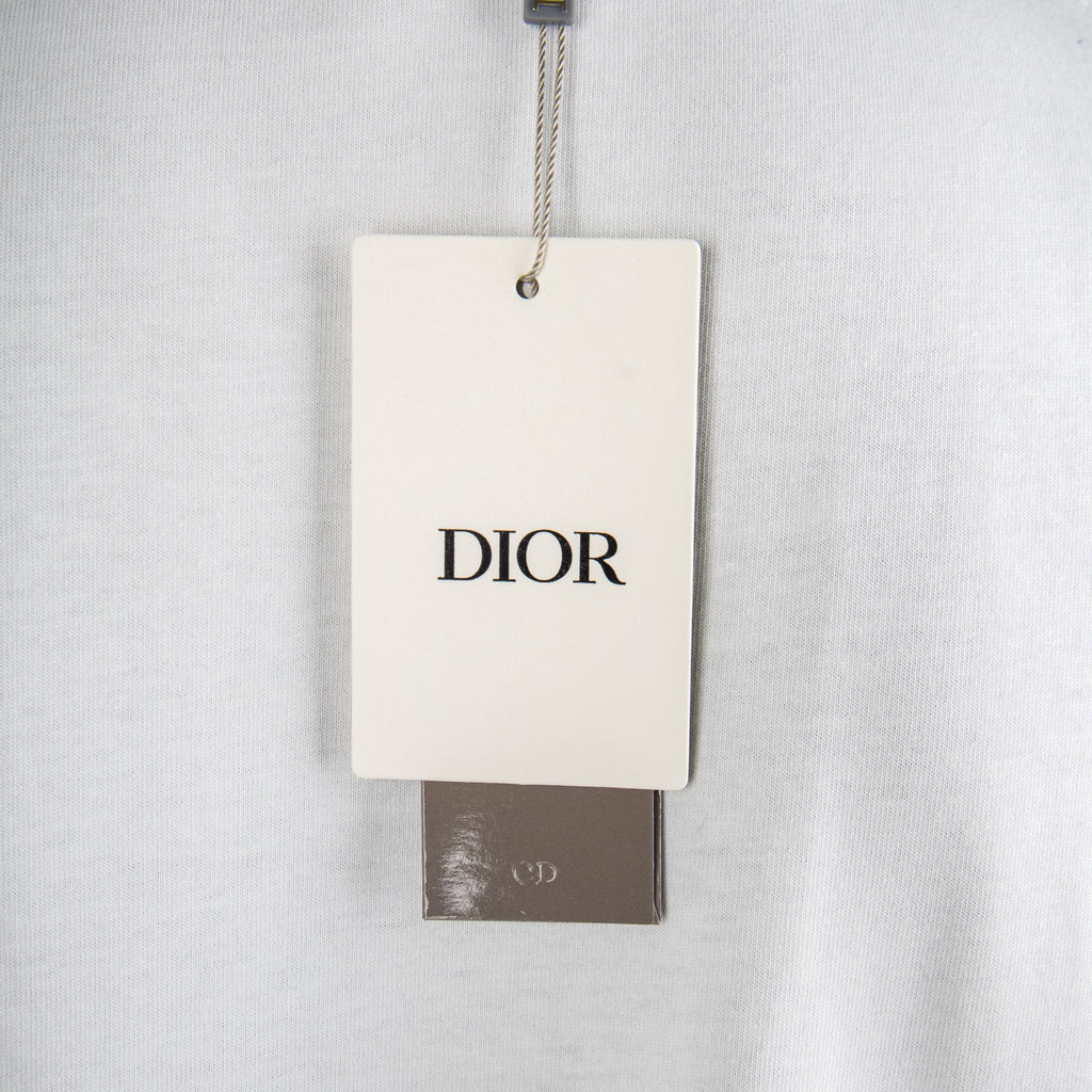 White T-shirt with Dior hang tag near neckline.