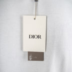 White T-shirt with Dior hang tag near neckline.
