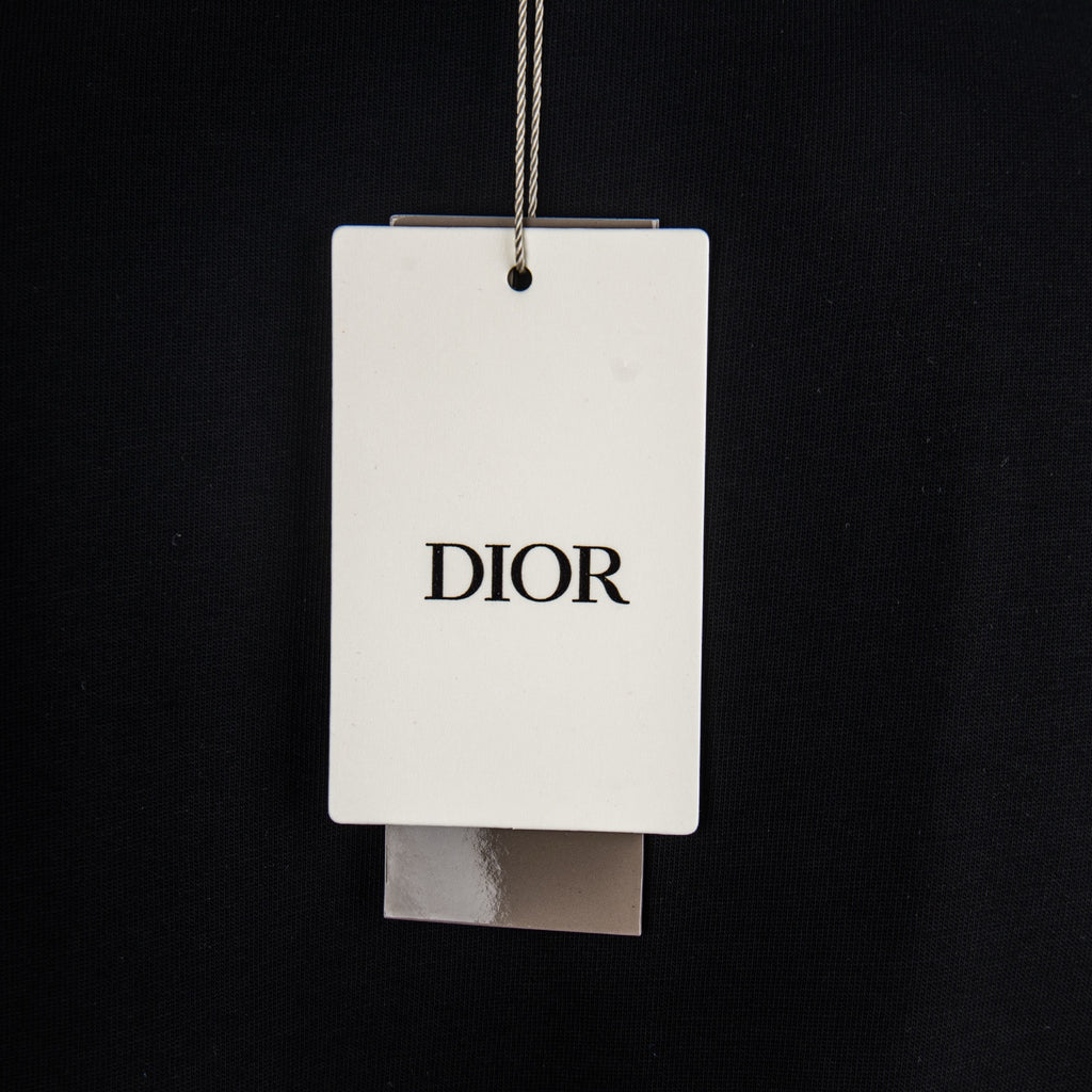 Black T-shirt with hanging retail tag marked DIOR