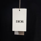 Black T-shirt with hanging retail tag marked DIOR