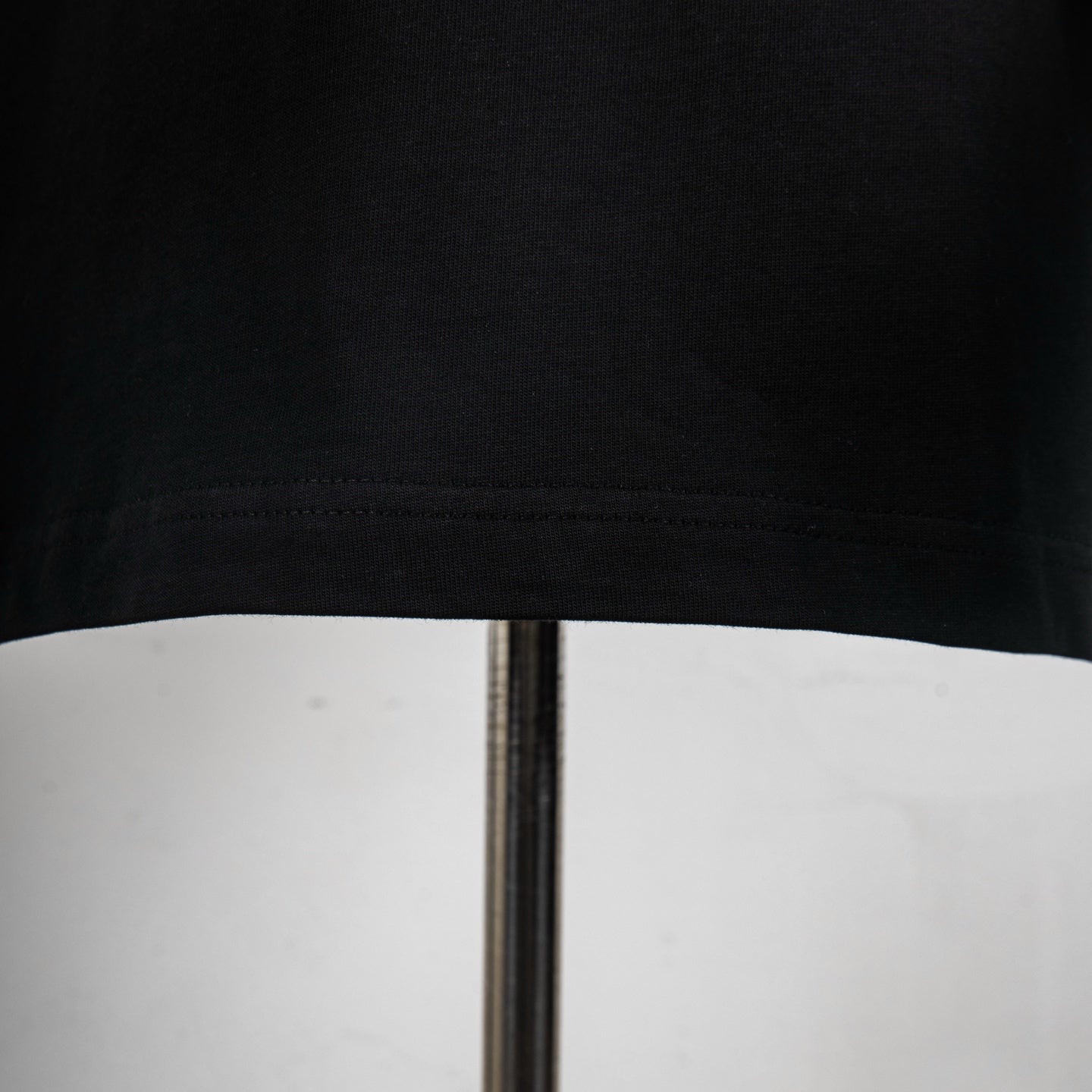 Black Dior T-shirt hem with visible stitching