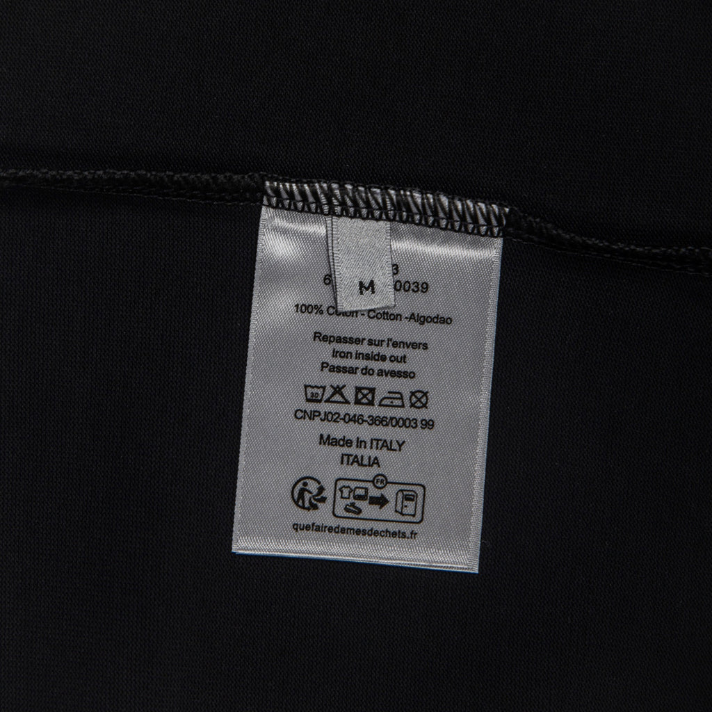 Black T-shirt inside care label with size and Made in Italia