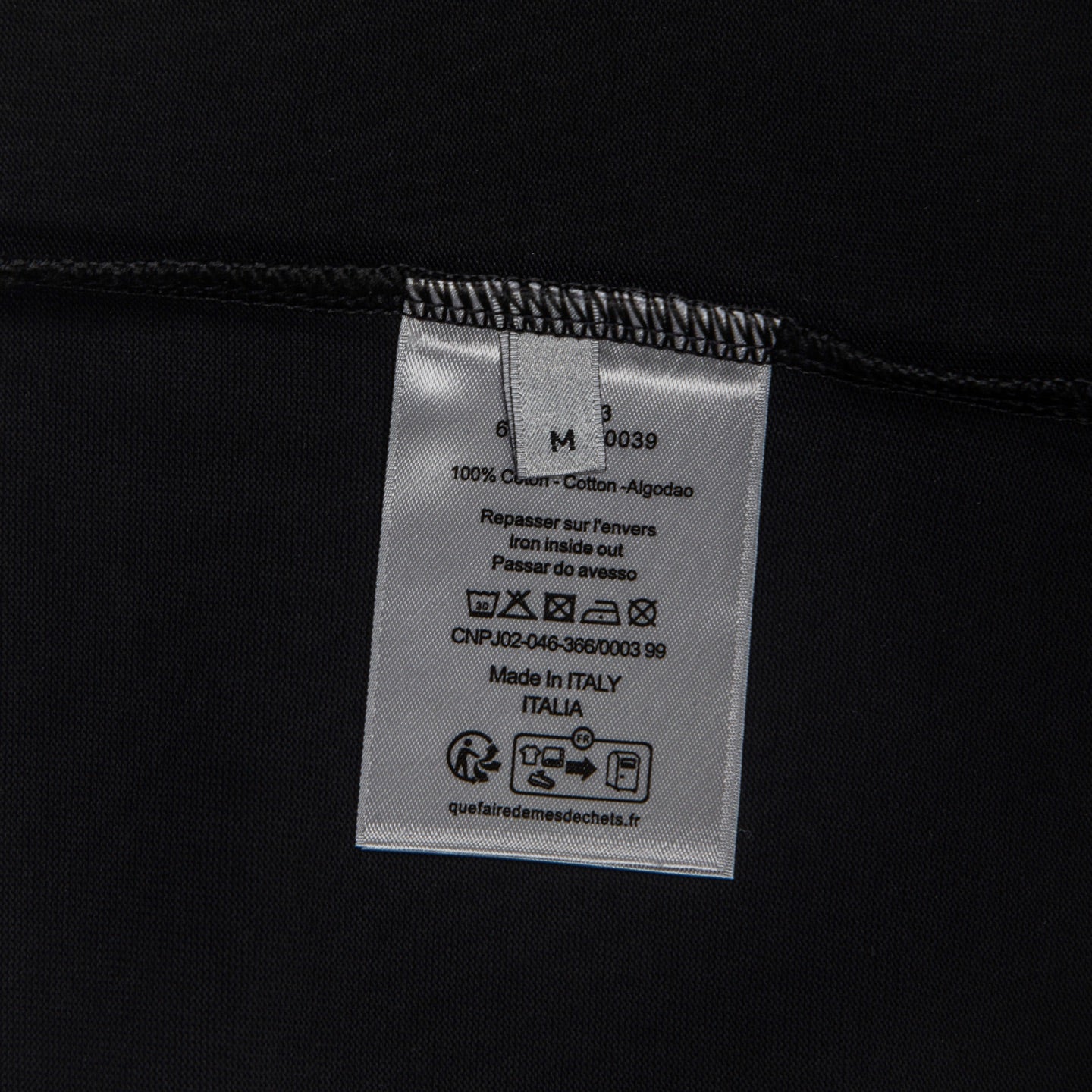 Black T-shirt inside care label with size and Made in Italia