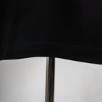 Black T-shirt hem and bottom seam close-up