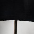 Black T-shirt hem with visible stitching