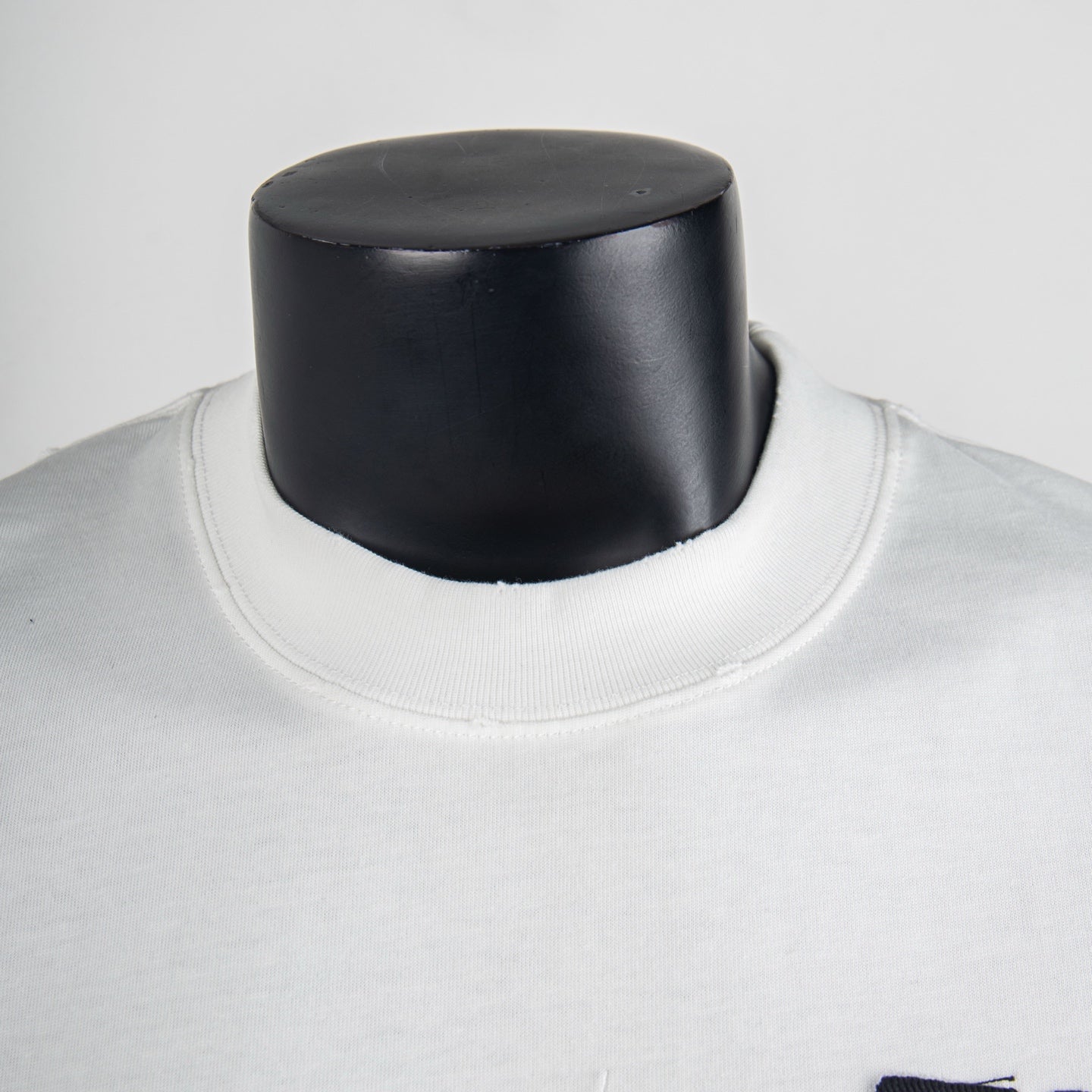 White crewneck T-shirt neckline with visible ribbed collar seam
