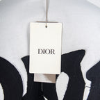 White T-shirt with hanging Dior brand tag near neckline