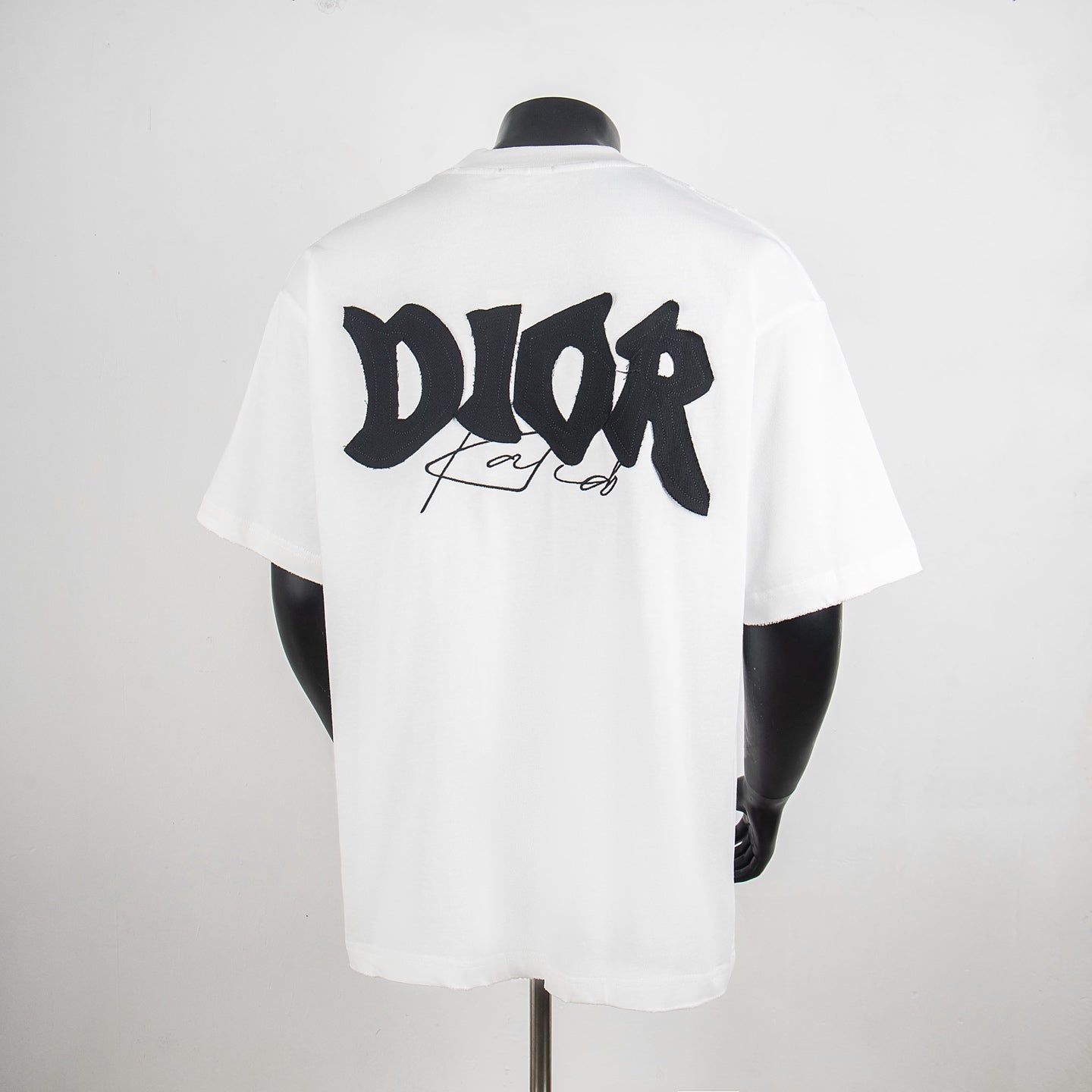 White crewneck short-sleeve T-shirt with large black back graphic and logo