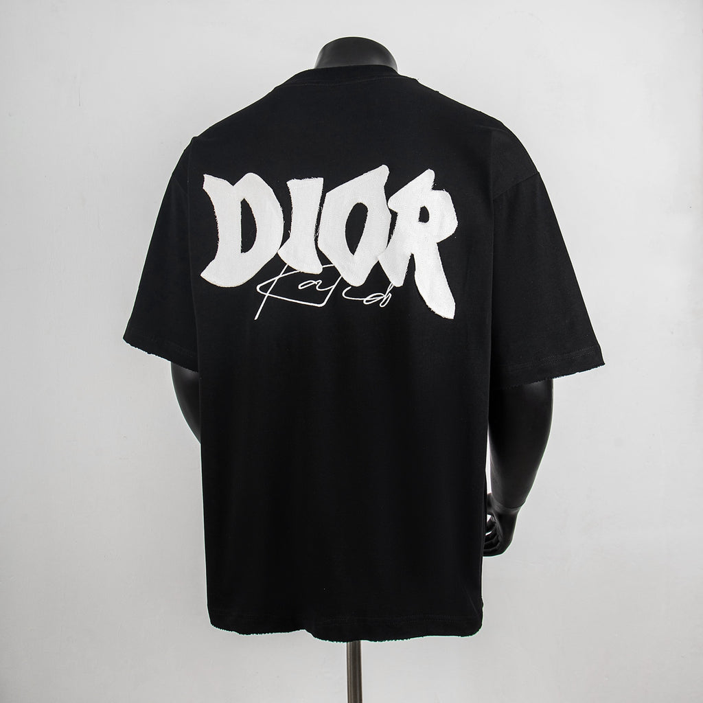 Black crew-neck T-shirt with large white Dior back graphic.