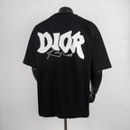 Black crew-neck T-shirt with large white Dior back graphic.