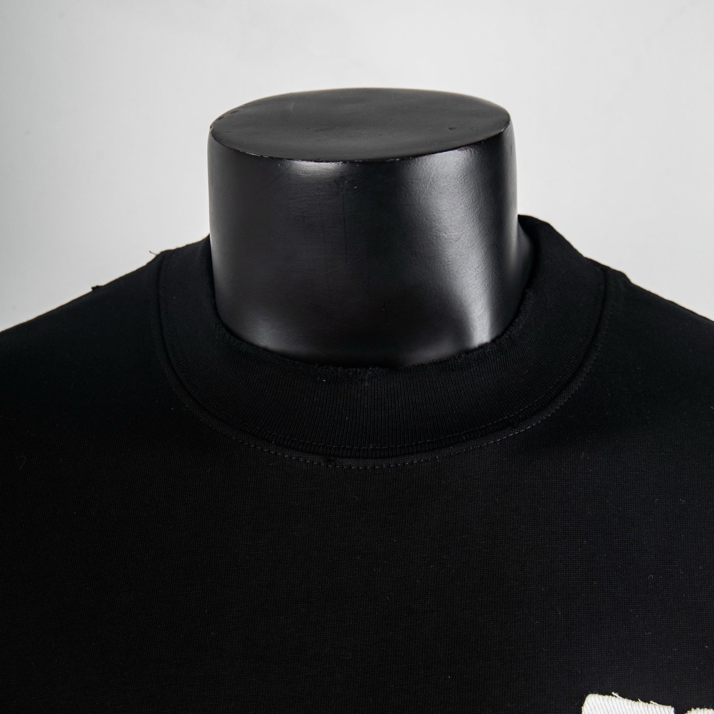 Black mock-neck T-shirt with ribbed collar and smooth jersey neckline
