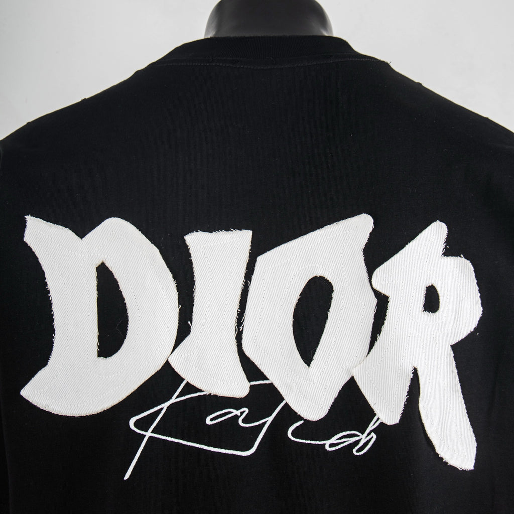 Black short-sleeve T-shirt with oversized white Dior logo across back