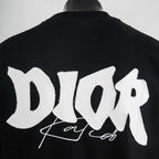 Black T-shirt with large white Dior back graphic and script.