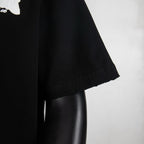 Black T-shirt short sleeve with stitched edge and slightly rolled hem.