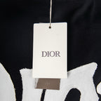 Black T-shirt with hanging white retail tag near neckline