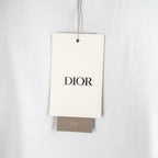 White fabric garment tag reading DIOR