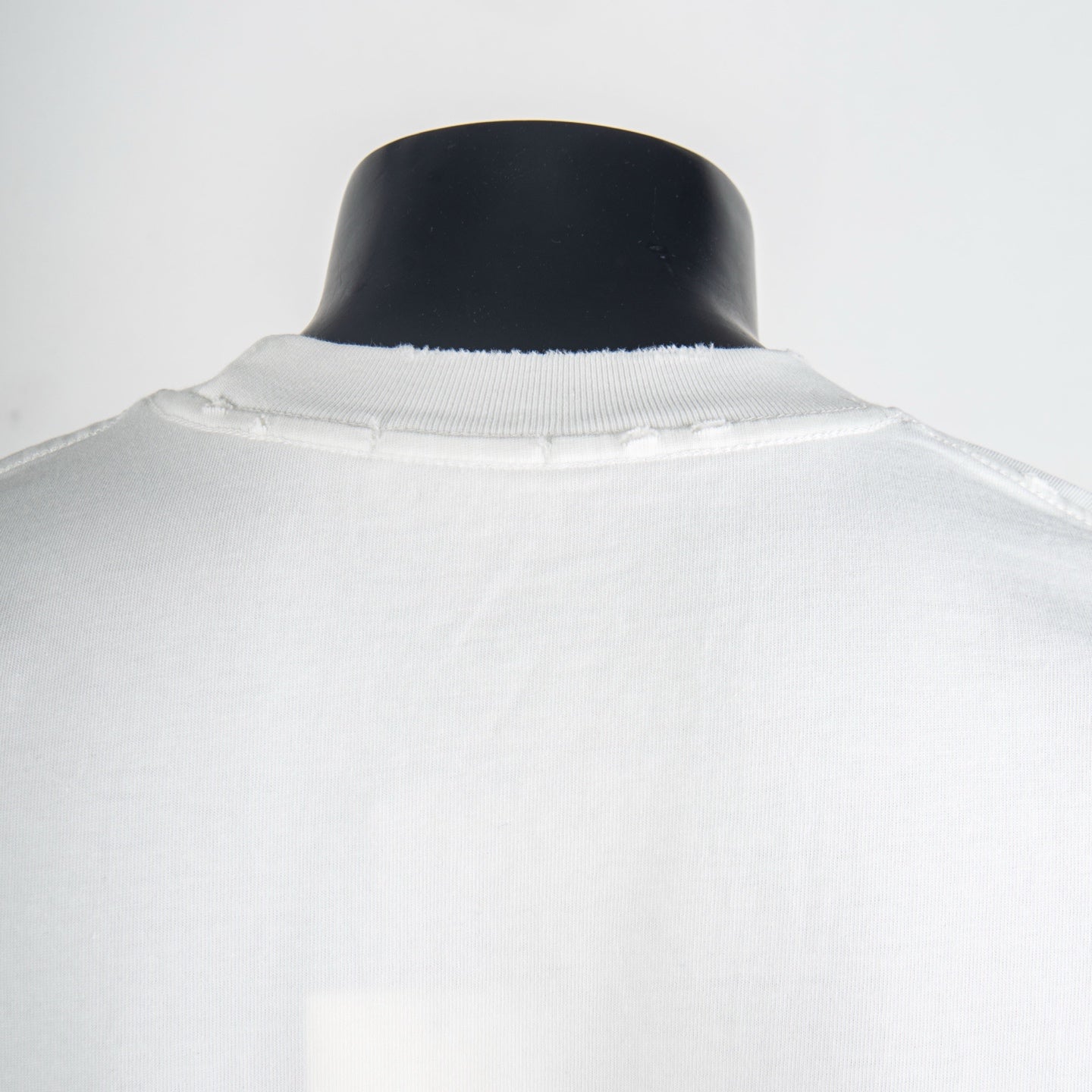 White T-shirt collar and shoulder seam, back view
