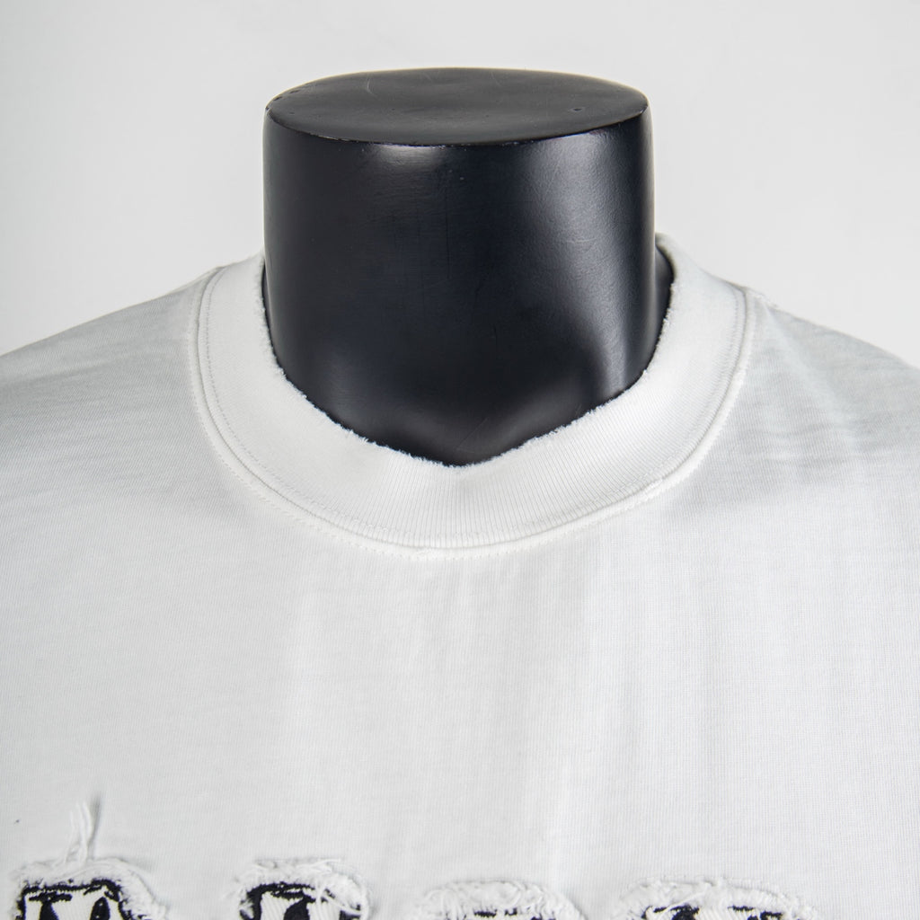 White T-shirt neckline close-up with black logo detail