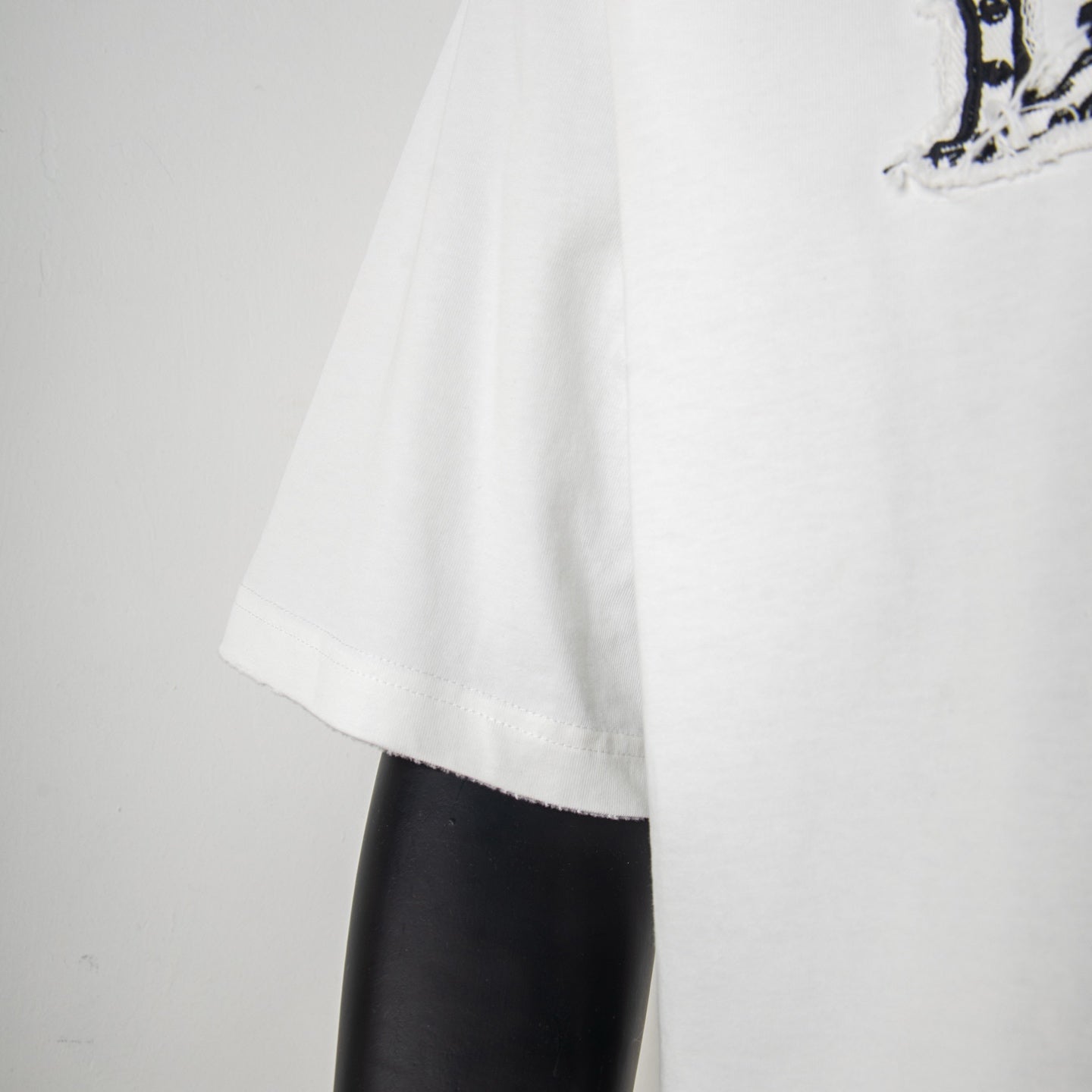 White T-shirt sleeve and side drape