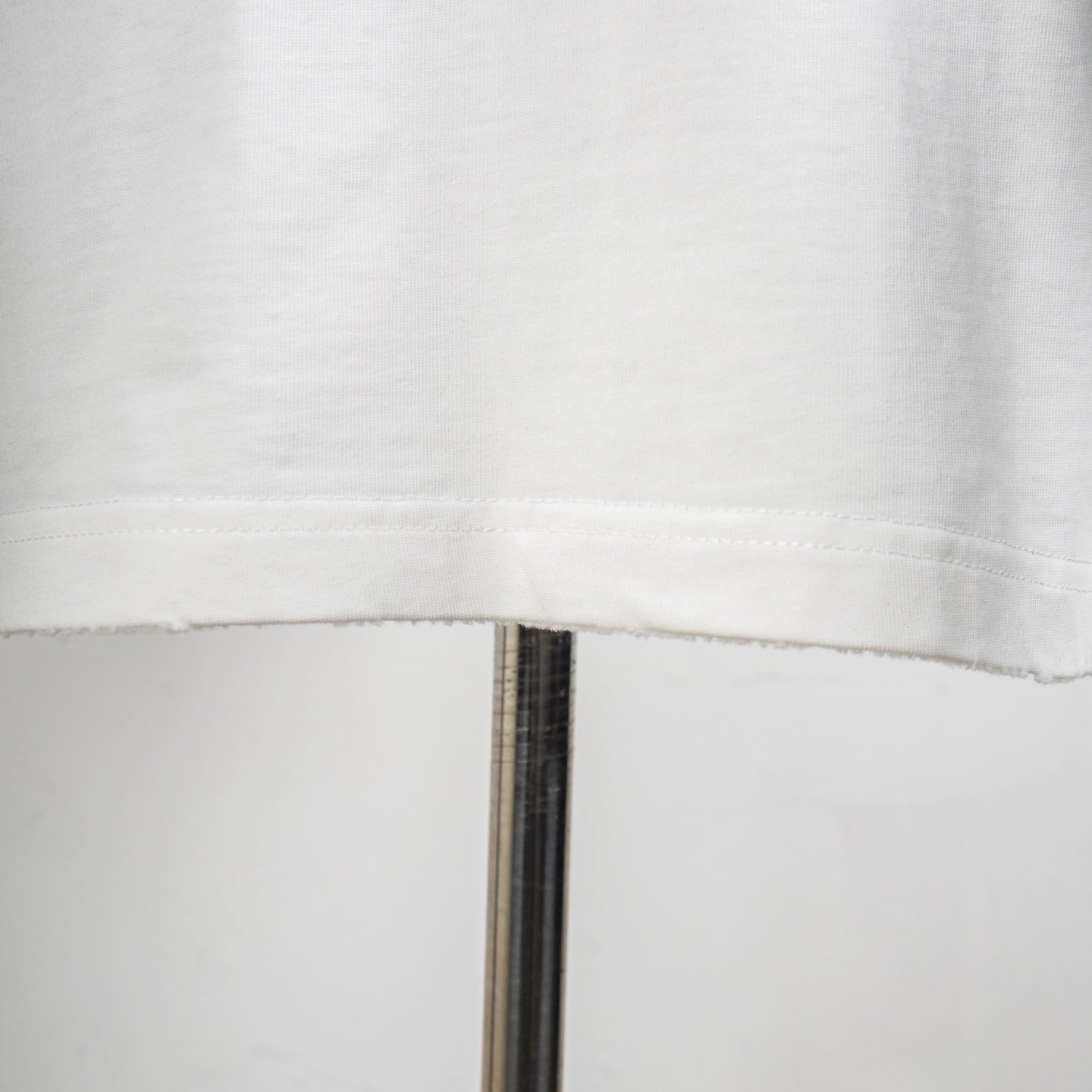 White T-shirt hem with stitched edge