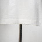 White T-shirt hem with visible stitching detail