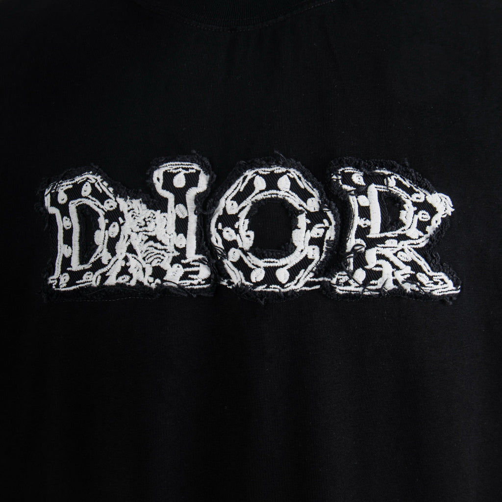 Black T-shirt with white "Dior" embroidered letter graphic