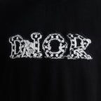 Black T-shirt with white "Dior" embroidered letter graphic