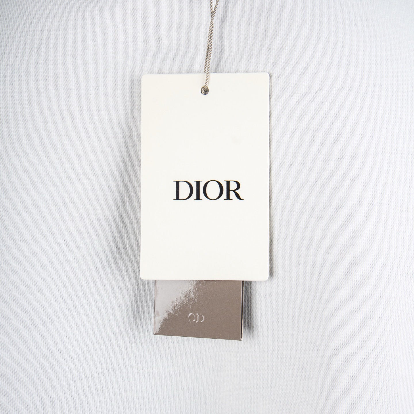 White Dior T-shirt with hanging DIOR brand tag