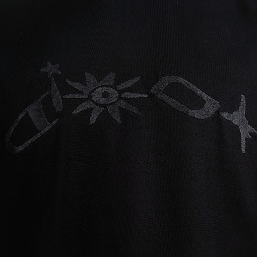 Black T-shirt front with large Dior-style logo print