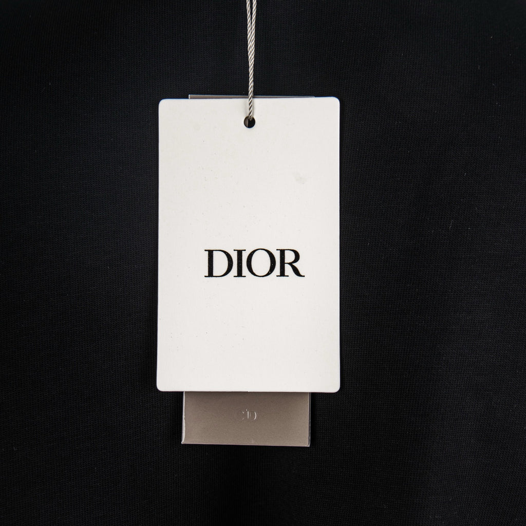 Dior branded hang tag and attached label on black T-shirt