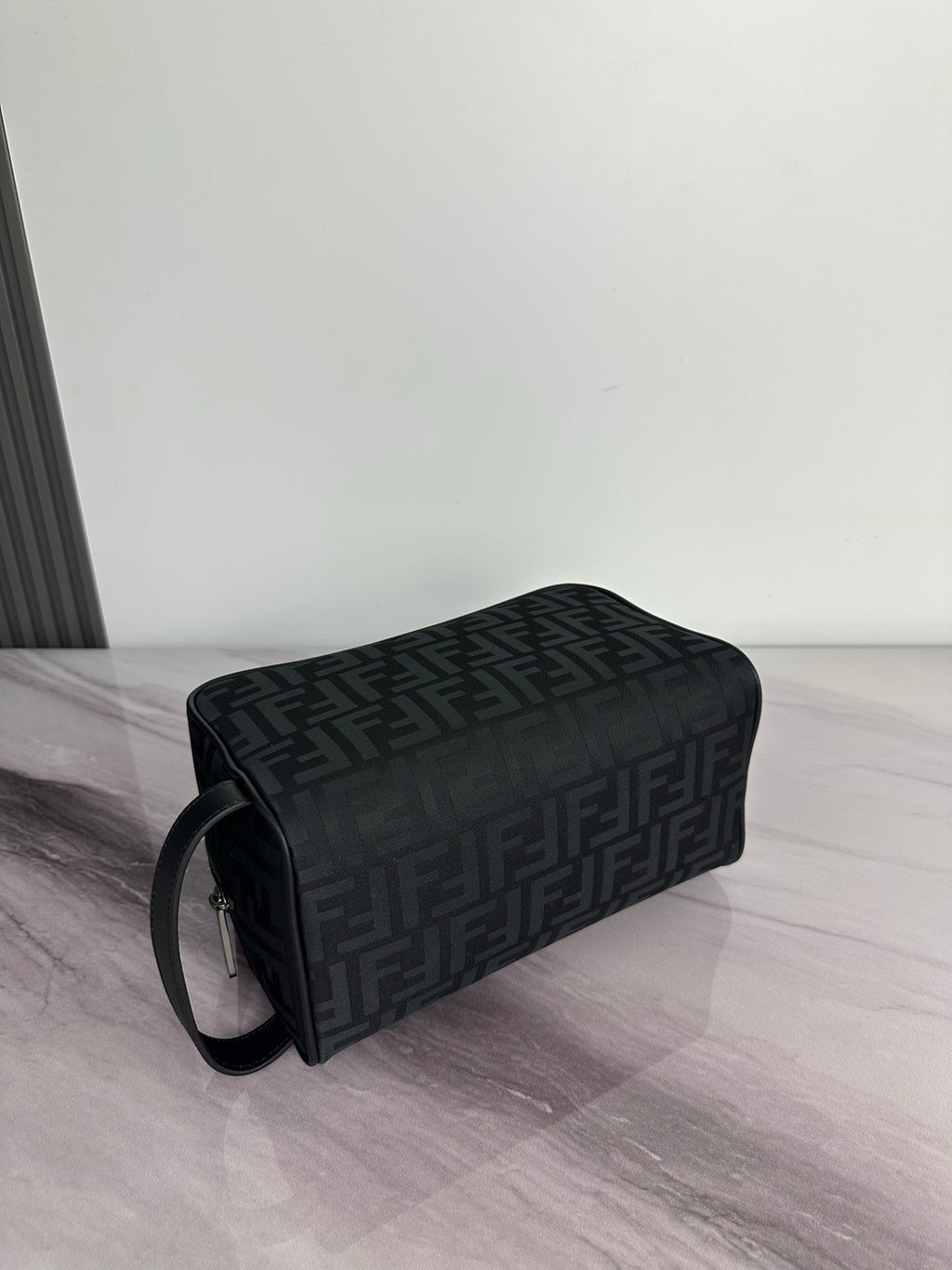 Fendi dark crossbody bag with FF logo pattern and shoulder strap, side view