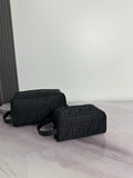 Fendi dark crossbody bag with repeating FF logo pattern and curved top zip