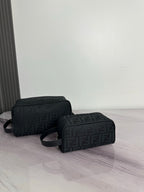 Fendi dark crossbody bag with repeating FF logo pattern and curved top zip