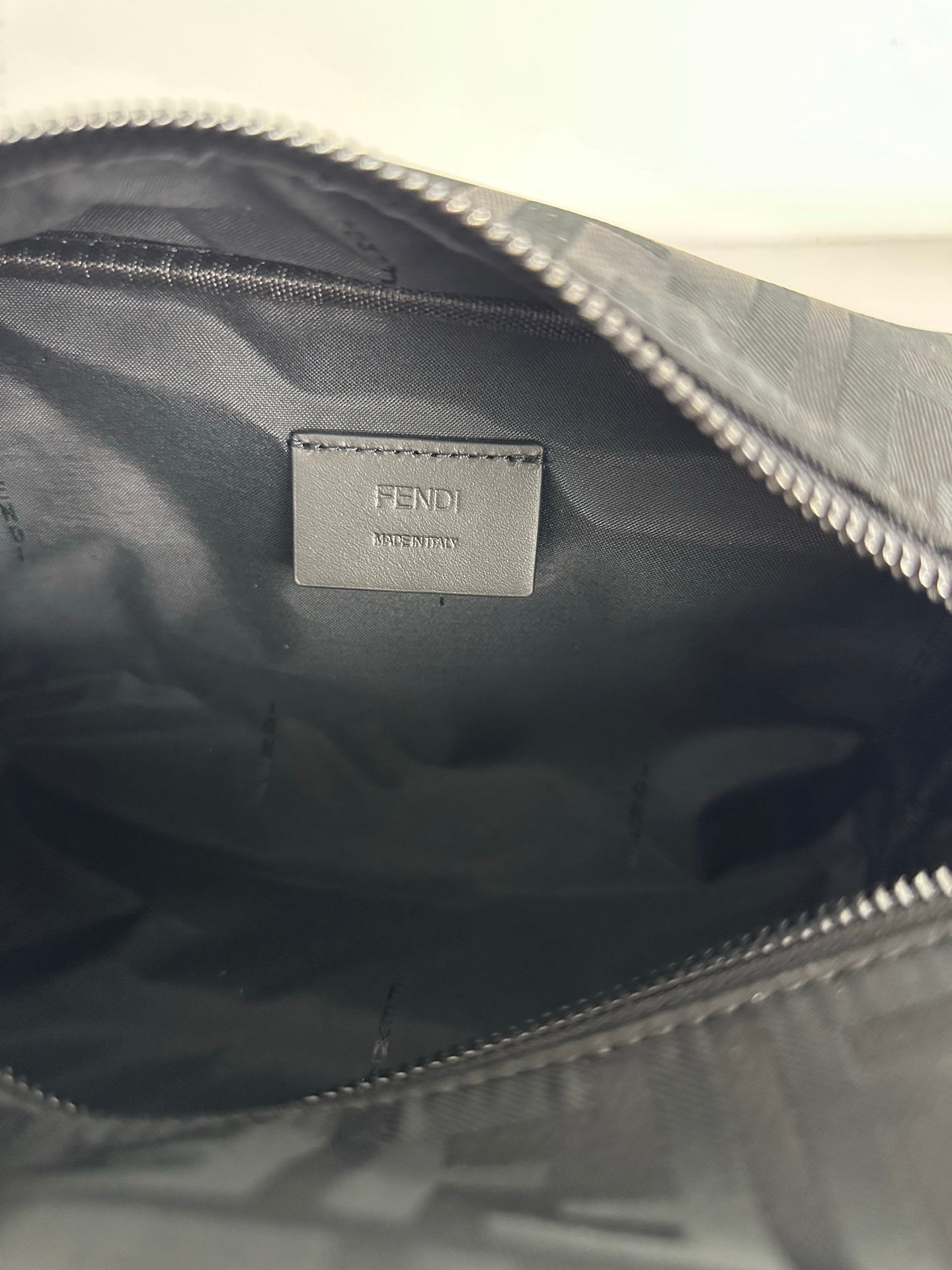 Fendi interior label on fabric lining with visible top zipper and stitching