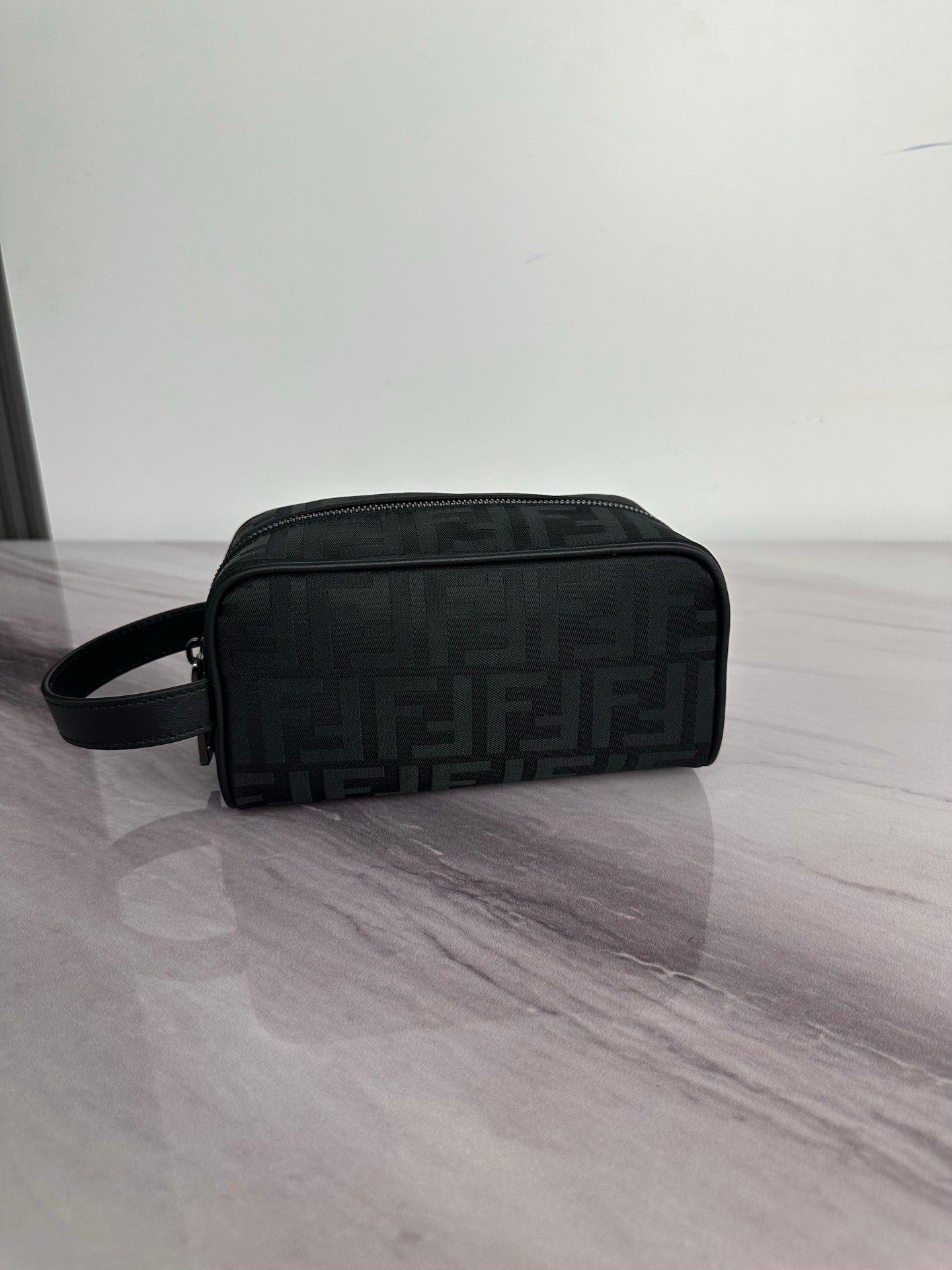 Fendi crossbody bag in dark monogram fabric, front zip pocket, wrist strap