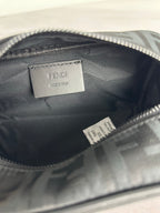 Fendi crossbody bag interior with Fendi label on fabric lining, zip-top opening