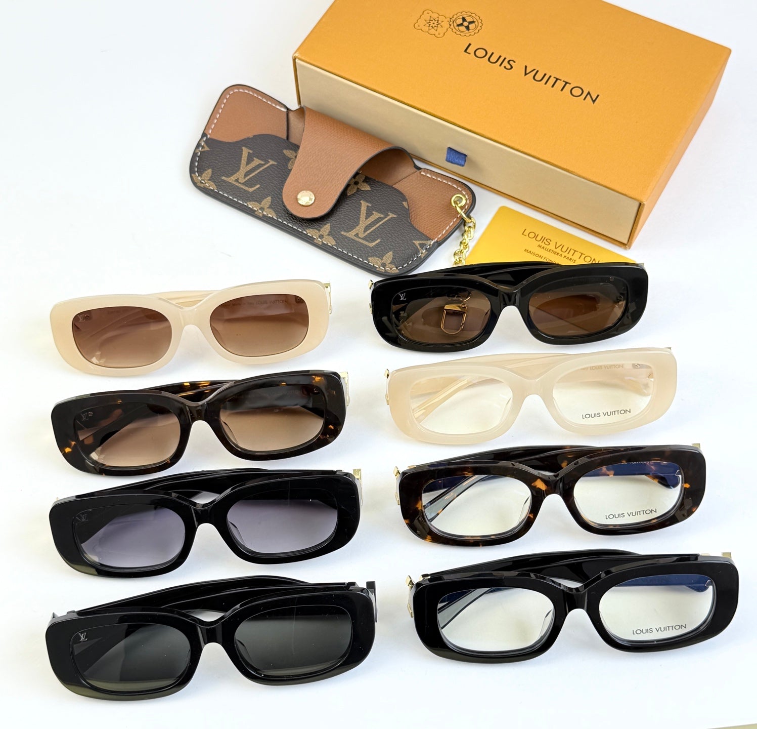 Louis Vuitton sunglasses set with multiple frames: black, cream, and beige with tinted lenses.