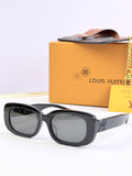Louis Vuitton sunglasses, black square frames with tinted lenses and gold logo accents.